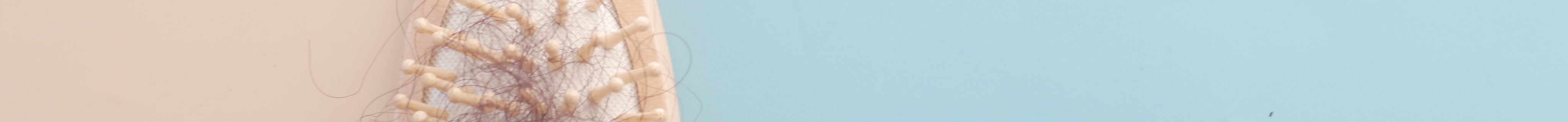 a-brush-with-lost-hair-on-table-top-down-2024-12-12-23-55-55-utc.jpg